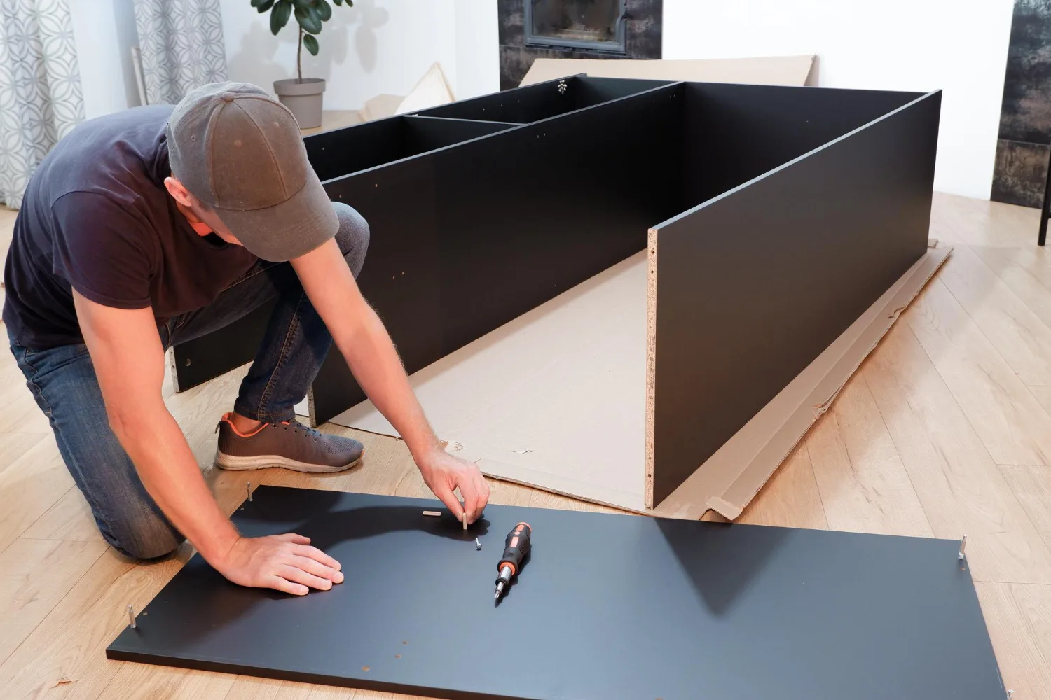 Installer assembling an IKEA kitchen cabinet system